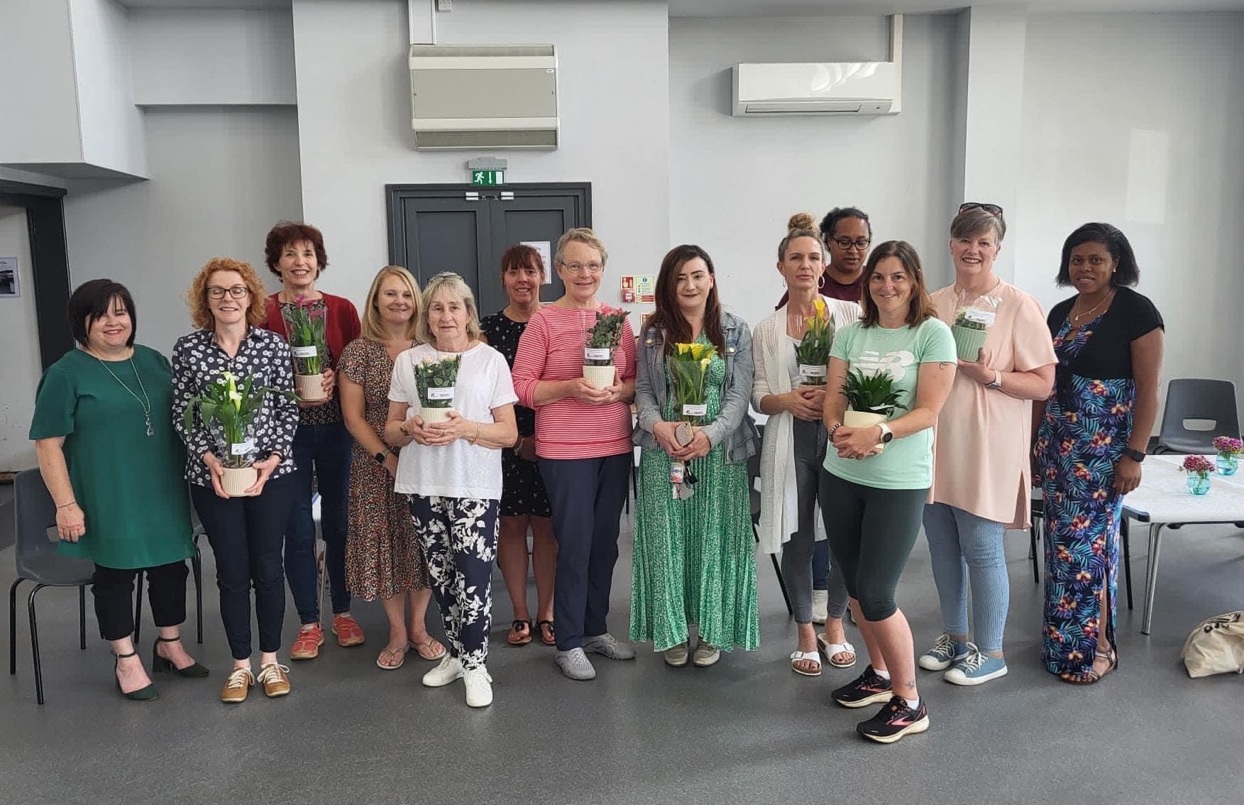 group of volunteers at FACES in Volunteer Week 2022 presented with plants.